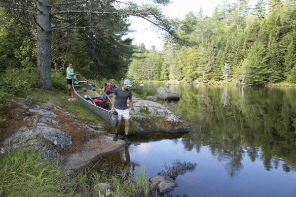 European adventurers Olivier Van Herck and Zoë Agasi put-in on the Saranac River. Photo by Mike Lynch