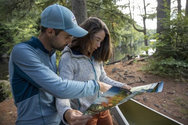 Olivier Van Herck and Zoë Agasi plan their route on the Saranac River in August. The European couple are on a four-year human-powered journey that has included biking through portions of Europe and South, Central and North America, sailing across the Atlantic Ocean, hiking on the Appalachian Trail and paddling the Northern Forest Canoe Trail.  Photo by Mike Lynch