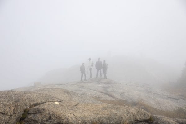Hikers near the summit on Cascade Mountain on Sunday, September 29, on a cloudy day. Photo by Mike Lynch