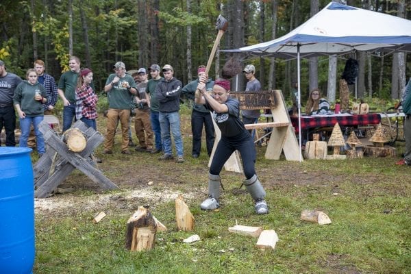 A Paul Smith's College student chops wood during the Adirondack Rural Skills and Homesteading Festival at the Paul Smith's College VIC. Photo by Mike Lynch