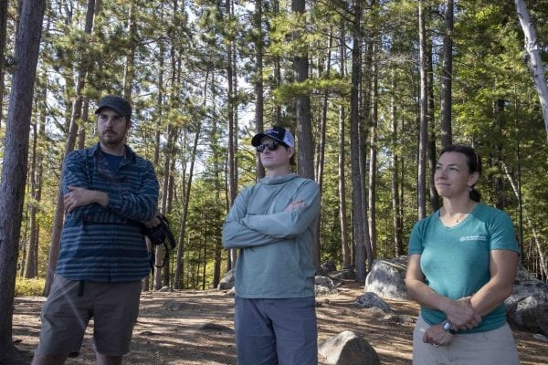 Ben Lawhon, education director with Leave No Trace Center for Outdoor Ethics in Boulder, Colorado, is flanked by Seth Jones of the Adirondack Mountain Club and Julia Goren of Adirondack Council at a campsite on Lower Saranac Lake. Lawhon did a four-day visit to the Adirondacks as part of consulting work he is doing here. Photo by Mike Lynch