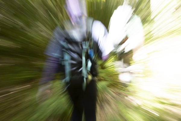 Explorer Publisher Tracy Ormsbee hikes through the Five Ponds Wilderness. This image was taken with a slow shutter speed to create a motion blur. Photo by Mike Lynch