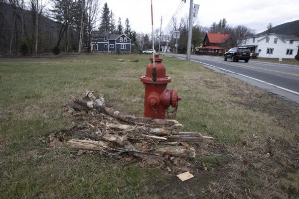 Flooding debris washed up against a fire hydrant after the East Branch of the Ausable River flooded during the Halloween storm. Photo by Mike Lynch