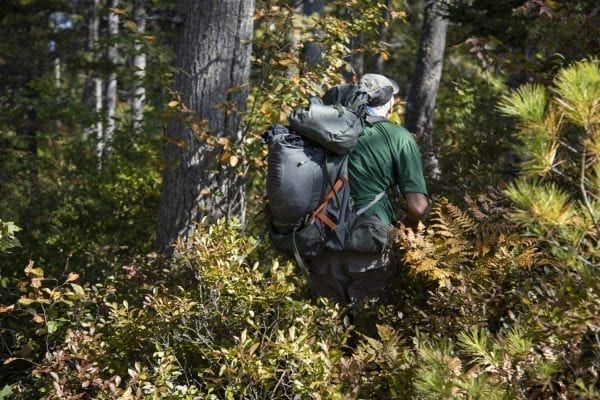 Sam Eddy bushwhacks through the Five Ponds Wilderness. Photo by Mike Lynch