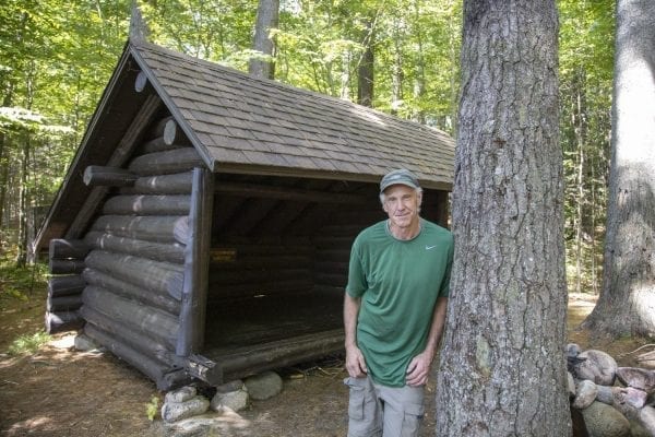 Sam Eddy poses in front of the Sand Lake lean-to. Photo by Mike Lynch