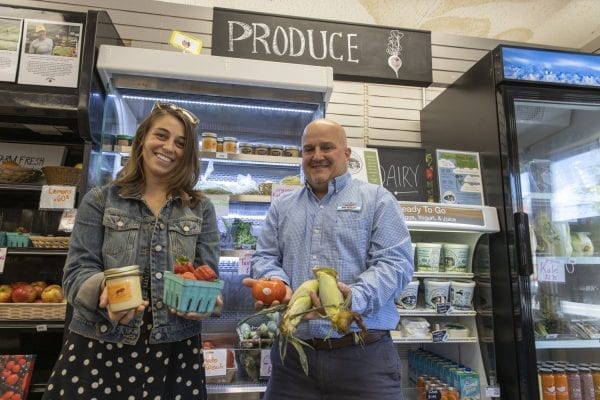 The Keeseville Pharmacy has filled a unique niche in its community by selling local food in addition to its normal products. Here, owner Dan Bosley, right, poses with ADK Action Farmacy Project Coordinator Kiana French in June. Photo by Mike Lynch