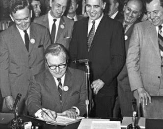 Nelson Rockefeller signing legislation.