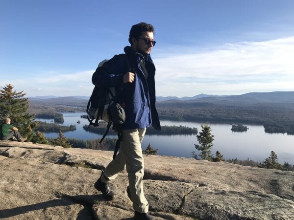 Reporter Ry Rivard hiking with lake in the background.
