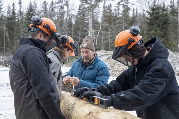 Bob Liseno teaches local students how to build a lean-to. Photo by Mike Lynch