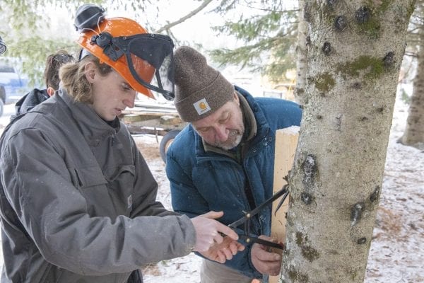 Bob Liseno is featured in the Trailblazer column of the March issue of the Explorer for his work with students in the BOCES program taught at the Adirondack Educational Center in Saranac Lake.  Here, Liseno teaches the students to build a lean-to on a cold January day. Photo by Mike Lynch