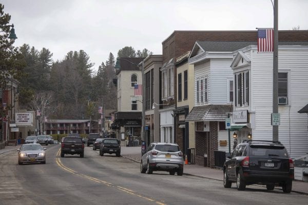 Downtown Lake Placid is  quiet on this late April day, but traffic still makes its way through town. Photo by Mike Lynch
