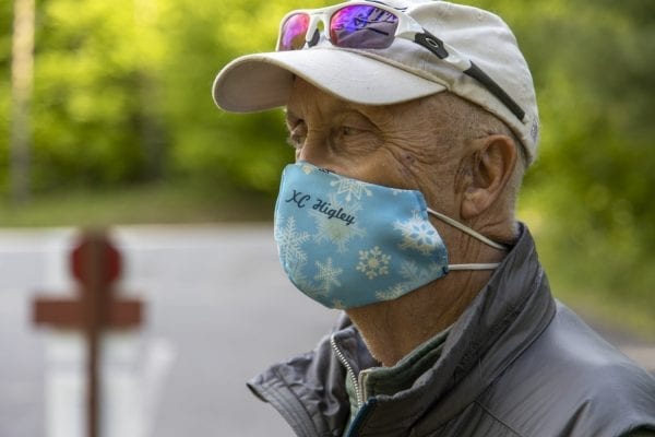 Ed Fuhr shows off a Higley face mask made by his wife, Judy. The Fuhrs were the focus of an article in the July issue because of the work they did on High Flow trails over the years. Photo by Mike Lynch