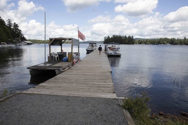 This photo gallery shows a sleepy but scenic Raquette Lake on a Friday afternoon. The quiet scene is a result of a slowdown in tourism due to the pandemic. Most years Friday afternoons in July in this tiny hamlet are much busier, with boats waiting for space on the bustling dock as vessels and visitors come and go. This gallery is part of "Snapshot," a multimedia series that captures a scene through photo galleries and videos. Photo by Mike Lynch