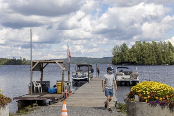 This photo gallery shows a sleepy but scenic Raquette Lake on a Friday afternoon. The quiet scene is a result of a slowdown in tourism due to the pandemic. Most years Friday afternoons in July in this tiny hamlet are much busier, with boats waiting for space on the bustling dock as vessels and visitors come and go. This gallery is part of "Snapshot," a multimedia series that captures a scene through photo galleries and videos. Photo by Mike Lynch