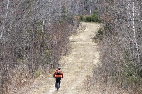 In May, multimedia reporter Mike Lynch joined former Explorer editor Phil Brown for a trip on the Sable Highlands Easement for a biking and hiking trip. The excursion started at the Fishhole Pond parking area, near Loon Lake. From there, they biked north on the D&H Road for about 2 miles, then turned left onto an old logging road and biked that a few miles to its end in a clearing with views of Loon Lake Mountains, Peaked Mountain and the Plumadore Range. On the way back, they got off their bikes and bushwhacked to a lookout on an unnamed peak with great views of the Sable Highlands and many peaks in the distance. DEC’s plans call for creating a mountain-bike loop around the unnamed peak and a hiking trail to the lookout. Neither has been done. These photos by Lynch are from that trip.