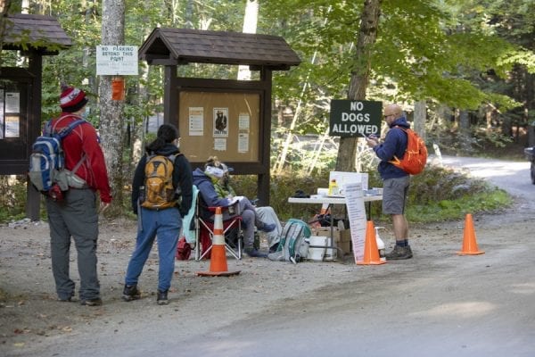 Hikers partake in a survey being conducted about usage. Photo by Mike Lynch
