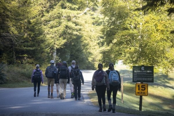 Hikers walk along Ausable Road on the way to the Adirondack Mountain Reserve trailhead. Photo by Mike Lynch