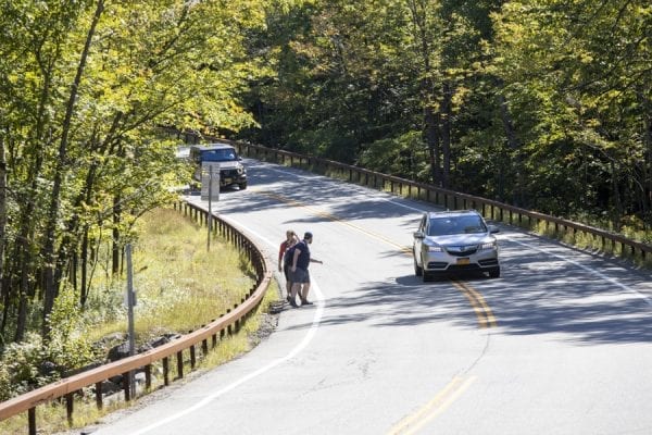 Hikers walk downhill along Route 73 from the direction of Chapel Pond. Photo by Mike Lynch