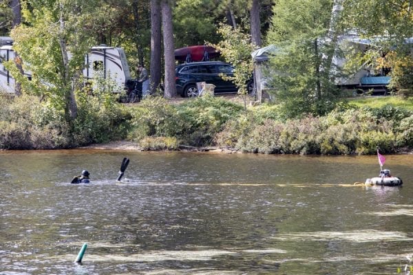 The Upper Saranac Foundation has worked to remove milfoil from the waters within Fish Creek Pond Campground in recent years.  Here divers work to remove the plant by hand. Photo by Mike Lynch