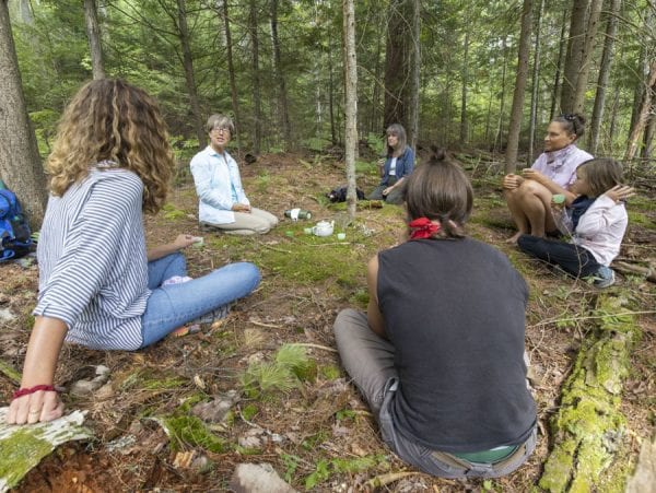Guide Helene Gibbens gathers with the group at the end of the forest bathing session. Photo by Mike Lynch