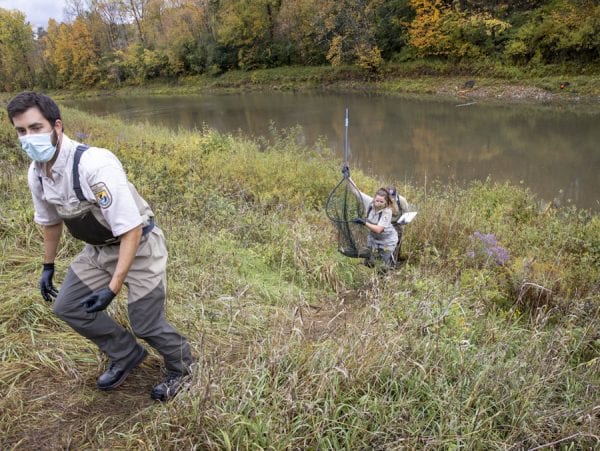 U.S. Fish and Wildife scientists bring a Boquet River salmon to a station where they tag and insert a tracking device into the fish. Photo by Mike Lynch