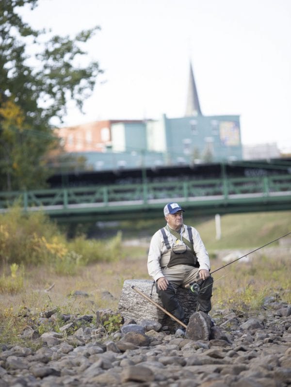 Herb Colby takes a break while fishing near the mouth of the Saranac River. Photo by Mike Lynch