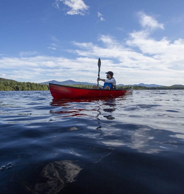 Chris Morris paddles Union Falls Pond on the Saranac River. Photo by Mike Lynch