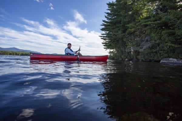 Chris Morris paddles Union Falls Pond on the Saranac River. Photo by Mike Lynch