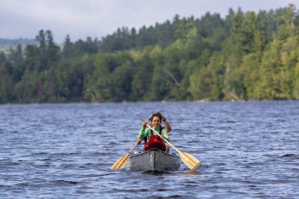 Zoe Agasi, front, and Oliver Van Herck paddle on Franklin Falls Pond. The pair were paddling from Old Forge to Fort Kent, Maine, in August 2019 on the Northern Forest Canoe Trail. Photo by Mike Lynch