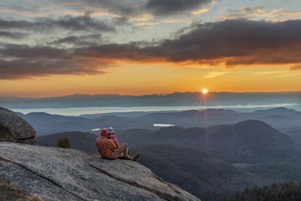 Shane Kenyon and Erika Guli enjoy a sunrise from Poke-O-Moonshine Mountain in the eastern Adirondacks in late November. Photo by Mike Lynch