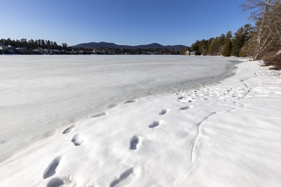 The ice out watch on area lakes has begun with recent warm weather. Mirror Lake in Lake Placid was completely covered with ice on March 22, but should see some melting in the near future. Photo by Mike Lynch