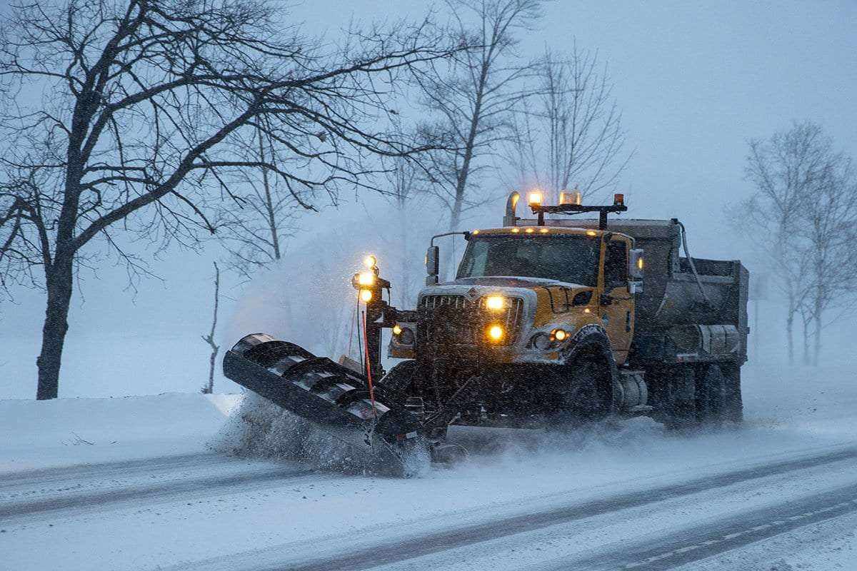 snow plow spreading road salt