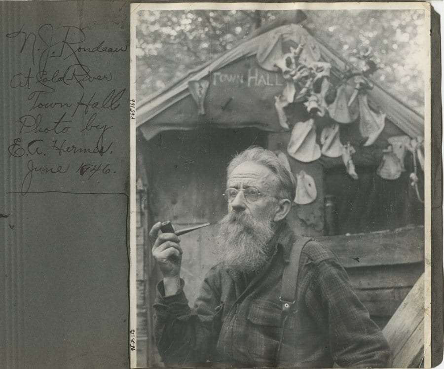 Hermit Noah John Rondeau smokes a pipe.