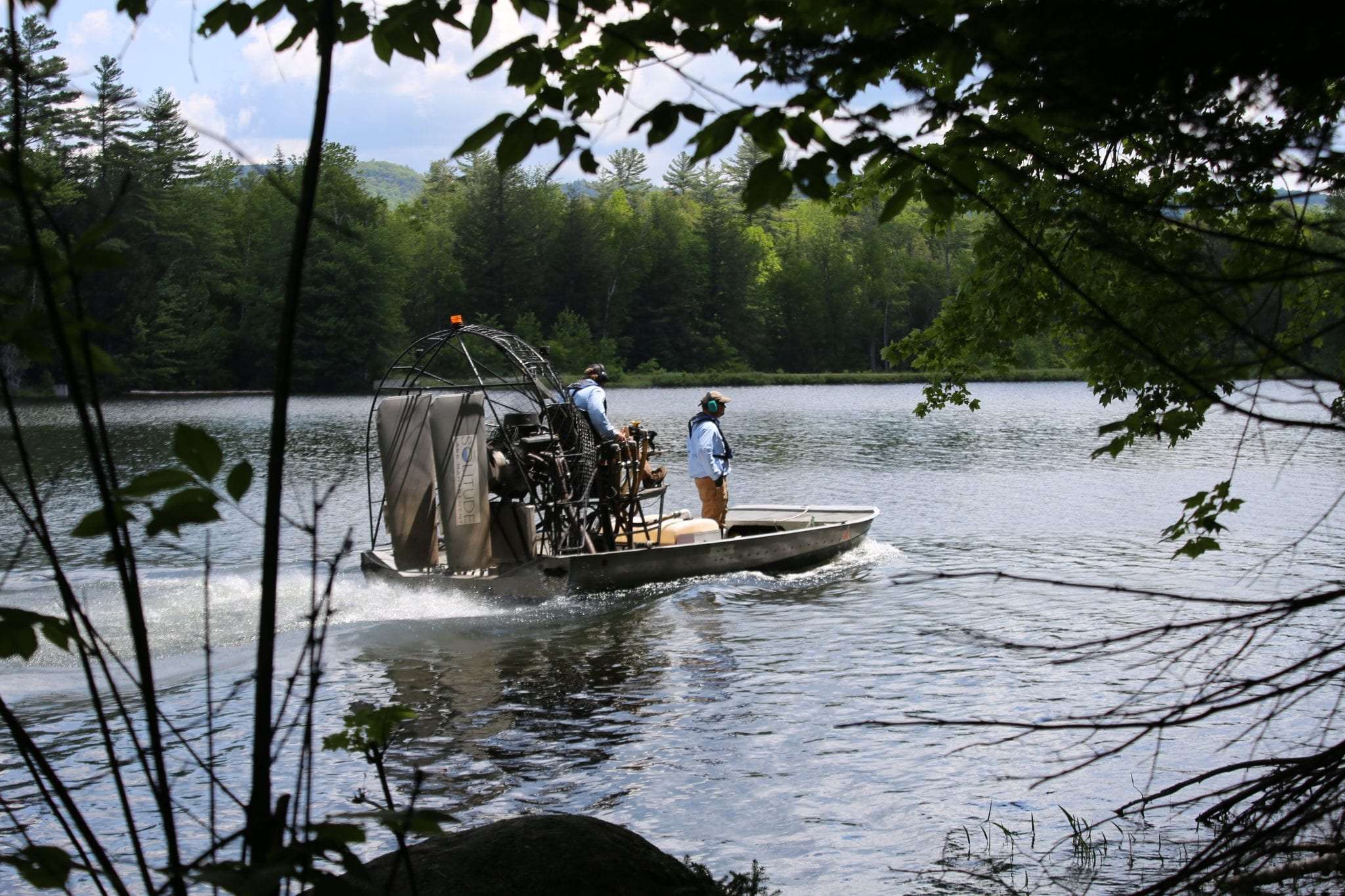 Boat on Minerva Lake treating for milfoil