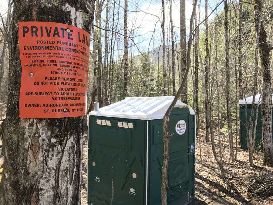 Portable toilets at the edge of the AMR parking lot.