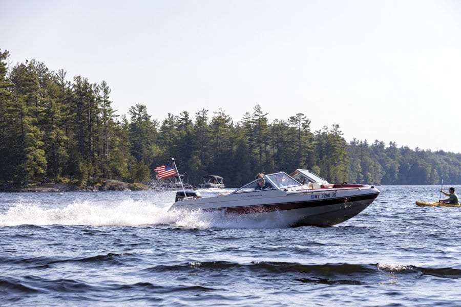 boater on saranac lake, which has been the center of a debate around carrying capacity of the lake