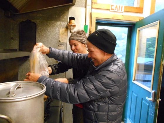 Staci and Jenna preparing dinner at Johns Brook Lodge.