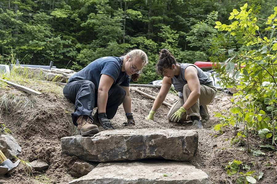 Northern Forest Canoe Trail trail stewards work on an access site along the Saranac River. Photo by Mike Lynch