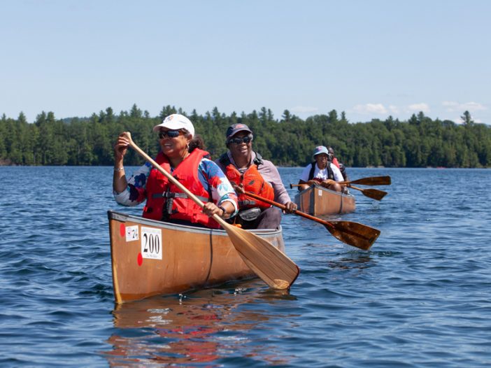 Canoeists paddle with Outdoor Afro.
