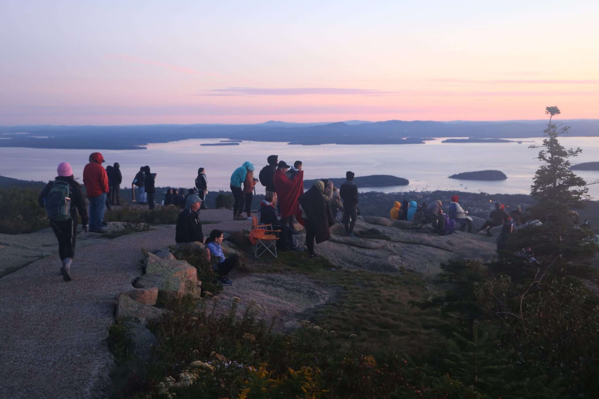 people watch the sun rise at Acadia National Park in Maine