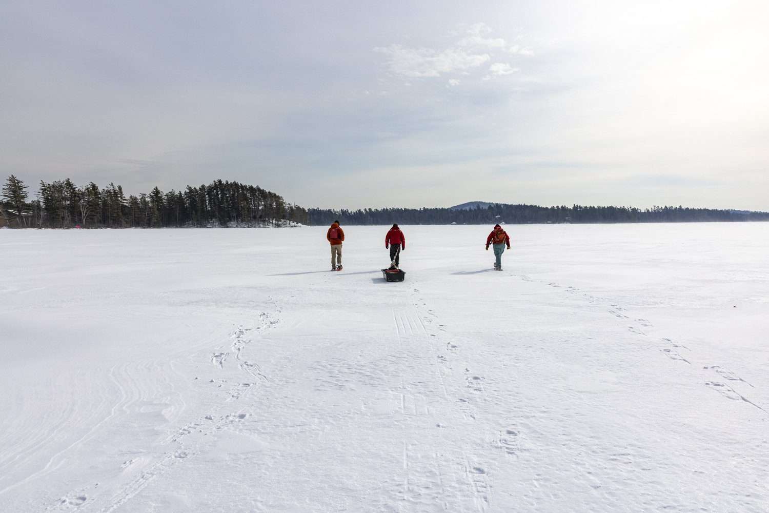 Scientists make their way across Lower St. Regis Lake to get ice data. 