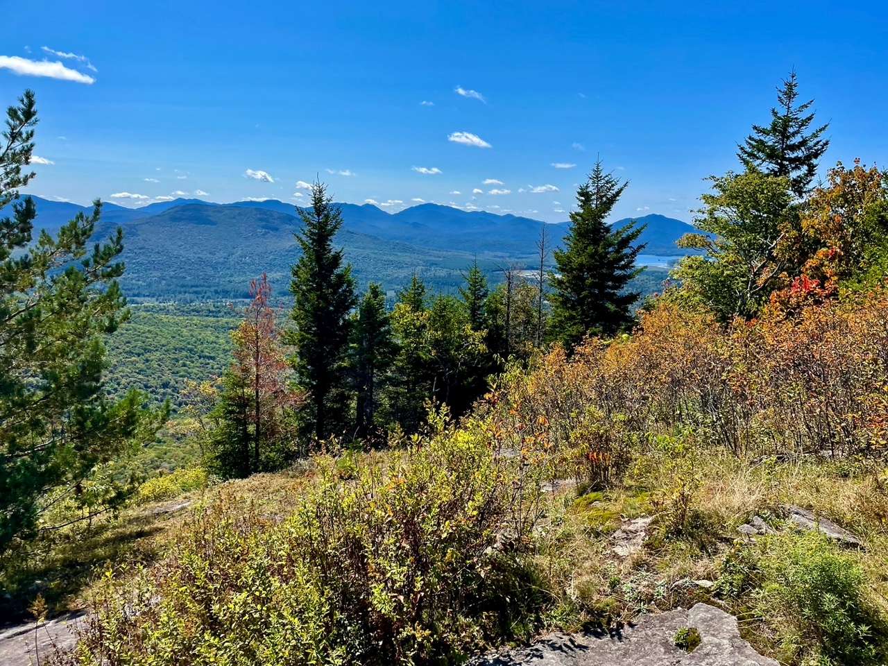 The view extends to the west of the southern peaks and Saranac lakes.