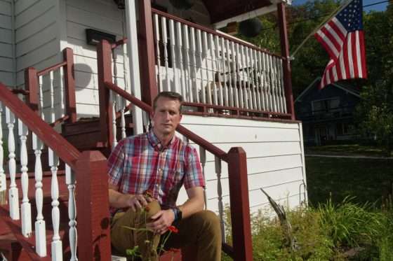 Jason Leon, a school teacher and member of the North Elba Town Board on Sept. 21, 2022 in front of his house.   Ken Aaron