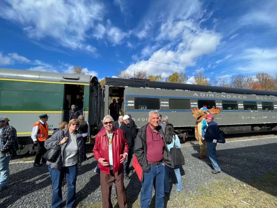 Passengers disembark the train to a welcoming crowd at Tupper Lake.