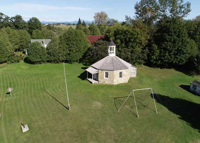 Built in 1826, the one-room, Octagonal Schoolhouse in Boquet may have been in operation into the 1960s.  The weathered flagpole still stands sentry over the structure, restored through a partnership between the Town of Essex, who owns the building, and the Essex Community Heritage Organization (ECHO). 
