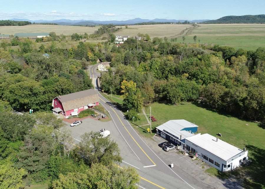 The Hamlet of Whallonsburg with its red Grange Hall in the center of the photo, the historic home of Patrons of Husbandry Chapter #954.  Whitcomb’s Garage, recently acquired by the nonprofit Whallonsburg Grange Hall, Inc. for a community center, is across the street.