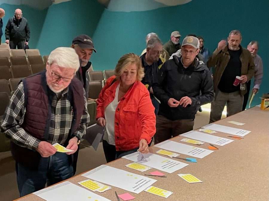 Participants in a housing forum vote on proposed solutions.