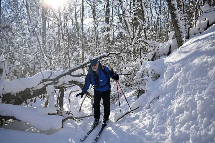 Doug steadies himself after crawling under the only significant blowdown along the 4.9 mile Peavine Swamp Trail.
