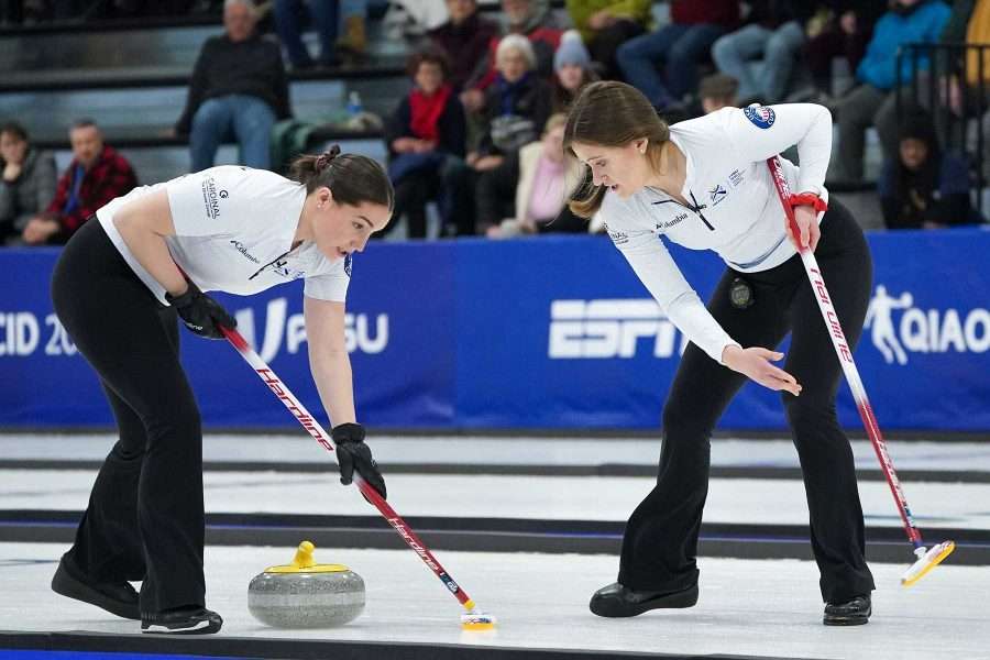 Sydney Mullaney (left) of the USA sweeps hard as teammate Anne Ohara (right) motions and yells to sweep harder during a bronze medal match against Great Britain at the 2023 FISU World University Games on January 20, 2023 in Saranac Lake, New York. (Photo by Kayla Breen/FISU Games)