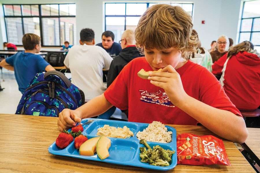 Sixth grader Dan Wells digs into a tray of cafeteria offerings at Willsboro Central School.